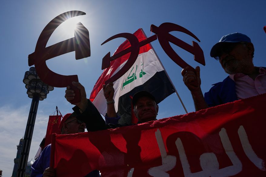 Supporters of the Iraqi Communist Party hold a symbolic hammer and sickle as they take part in the May Day celebration in Baghdad, Iraq, Friday, May 1, 2026. (AP Photo/Hadi Mizban) ** FILE **