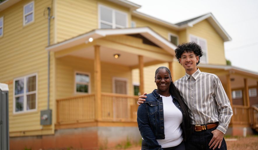 Home owners Phileena Daniel and Oswaldo Herrera pose for a photo in Langston Park, April 13, 2026, in Atlanta. (AP Photo/Mike Stewart)