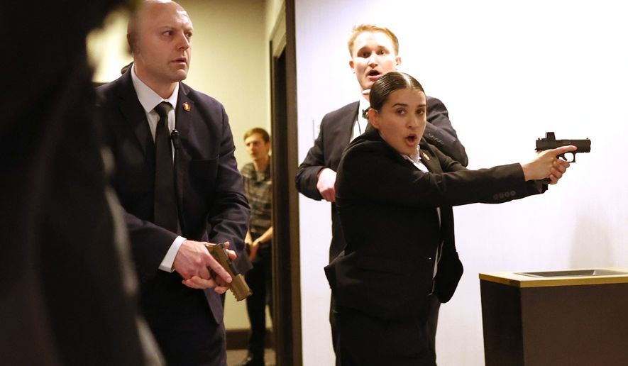 FILE - Secret service agents respond when a man, who authorities say, tried to storm the White House Correspondents' Association dinner with guns and knives, in Washington, April 25, 2026. (AP Photo/Tom Brenner, File)