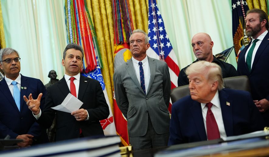 Dr. Marty Makary, commissioner of the Food and Drug Administration, speaks while, from left, National Institutes of Health Director Dr. Jay Bhattacharya, Health and Human Services Secretary Robert F. Kennedy Jr., Joe Rogan, President Donald Trump, Joe Rogan and CEO of Americans for Ibogaine W. Bryan Hubbard listen in the Oval Office of the White House, Saturday, April 18, 2026, in Washington. (AP Photo/Julia Demaree Nikhinson)