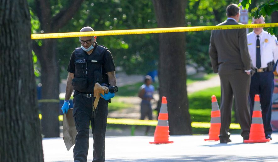 A member of the forensics team walks near the scene after a person was shot by law enforcement near the Washington Monument in Washington, Monday, May 4,, 2026. (AP Photo/Rod Lamkey Jr.)
