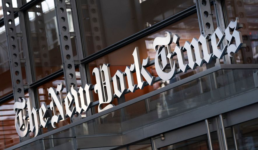 A sign for The New York Times is displayed above the entrance to its building in New York on May 6, 2021. (AP Photo/Mark Lennihan, File)