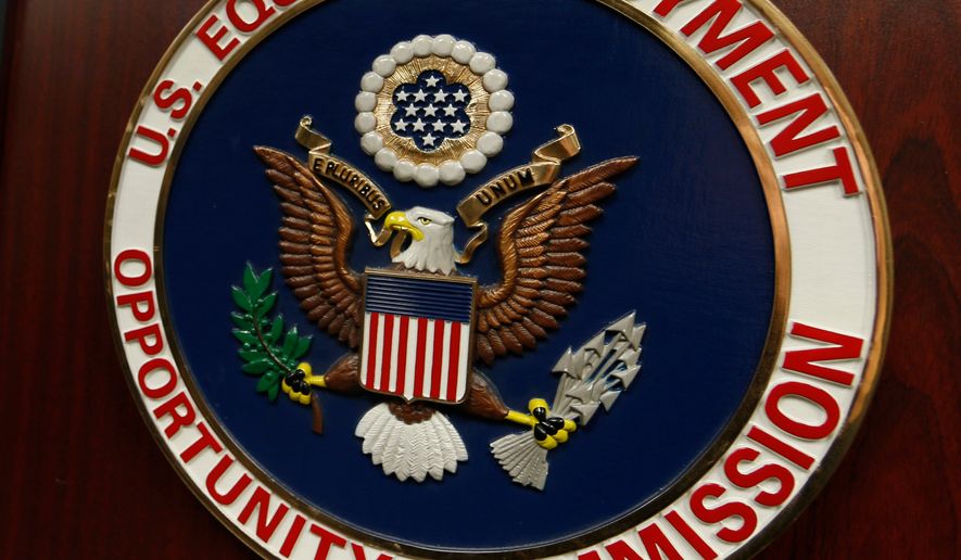 The emblem of the U.S. Equal Employment Opportunity Commission (EEOC) is displayed on a podium in Vail, Colo., on Feb. 16, 2016. (AP Photo/David Zalubowski) **FILE**