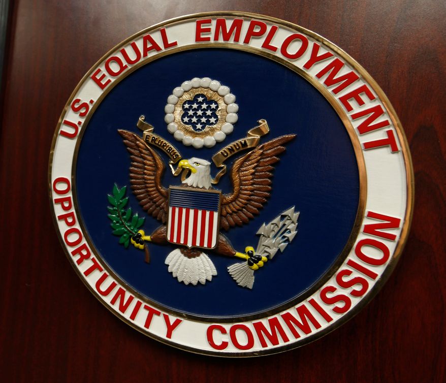 The emblem of the U.S. Equal Employment Opportunity Commission (EEOC) is displayed on a podium in Vail, Colo., on Feb. 16, 2016. (AP Photo/David Zalubowski) **FILE**