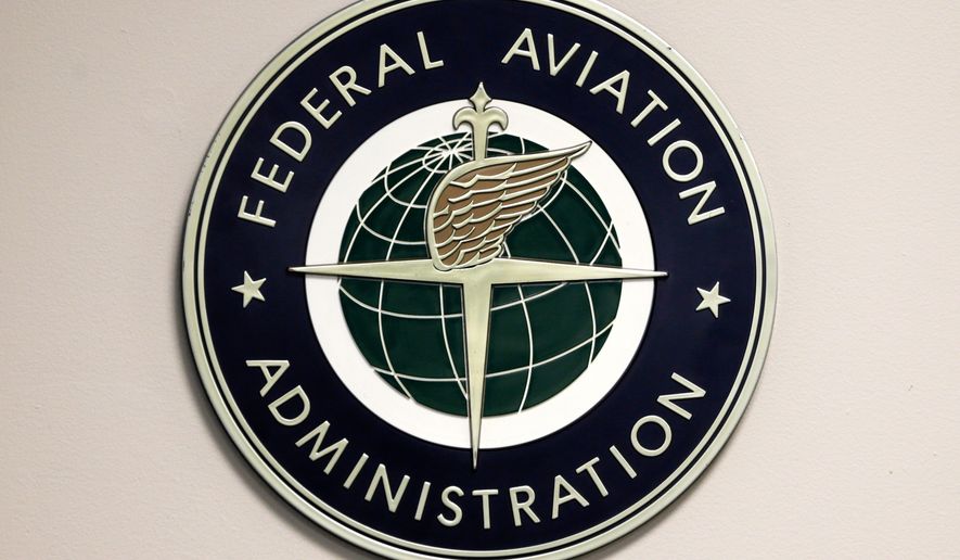 A Federal Aviation Administration logo is displayed in the tower at John F. Kennedy International Airport in New York, March 16, 2017. (AP Photo/Seth Wenig, File)