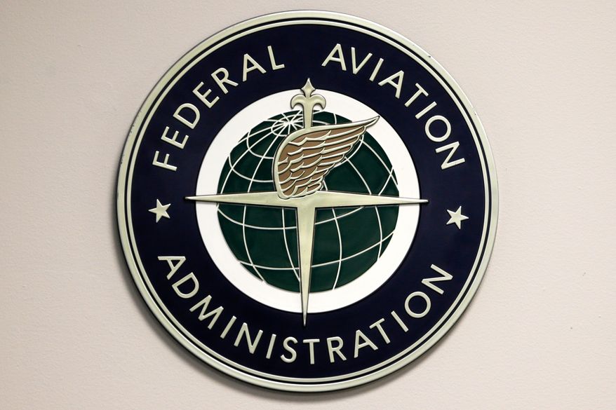 A Federal Aviation Administration logo is displayed in the tower at John F. Kennedy International Airport in New York, March 16, 2017. (AP Photo/Seth Wenig, File)