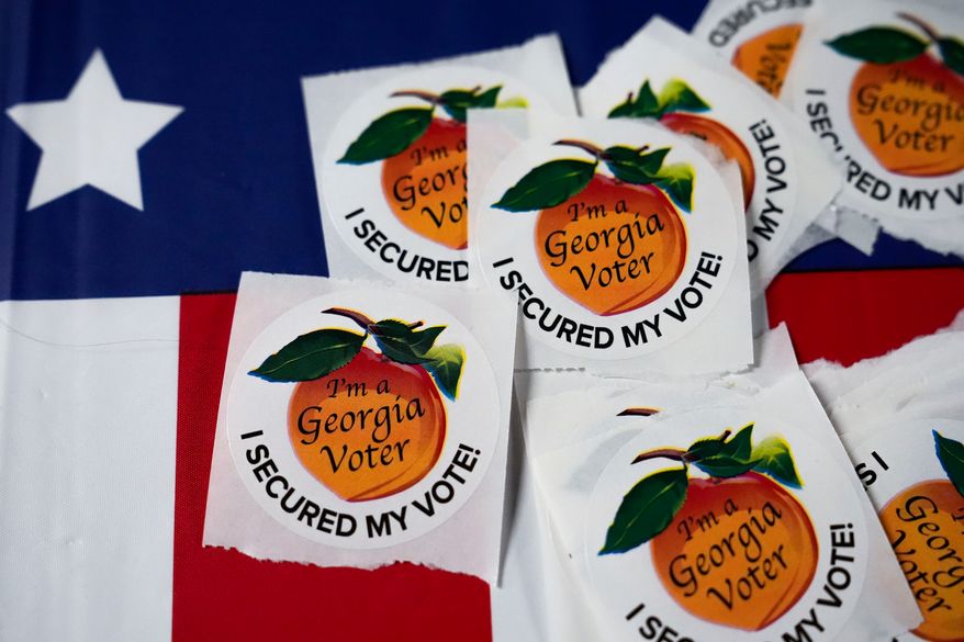 Stickers sit on a table inside a polling place, Nov. 5, 2024, in Atlanta. (AP Photo/Brynn Anderson, File)