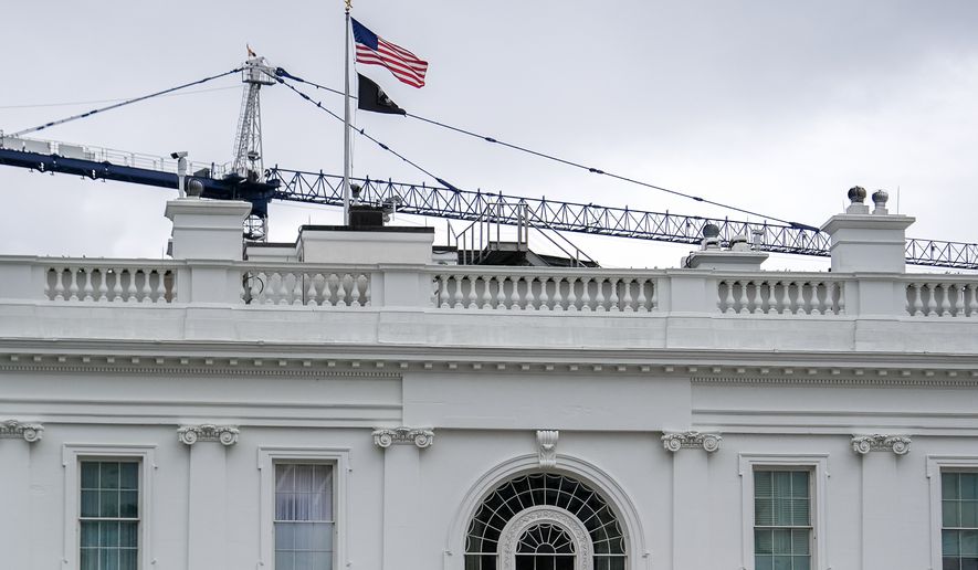 A crane being used to construct the new White House ballroom is seen above the White House, Sunday, April 19, 2026, in Washington. (AP Photo/Julia Demaree Nikhinson)