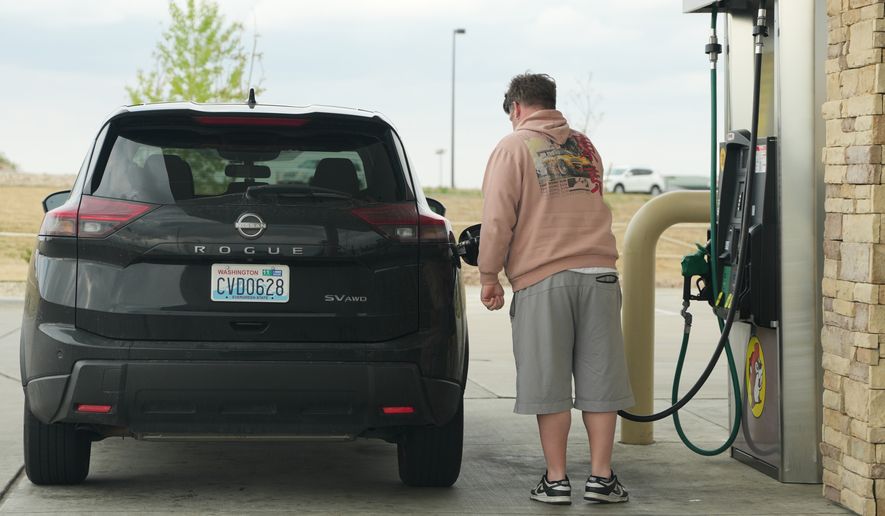 A motorist fills up the tank of a utility vehicle at a pump at a Buc-ee's gasoline stop Thursday, April 30, 2026, in Johnstown, Colo. (AP Photo/David Zalubowski)