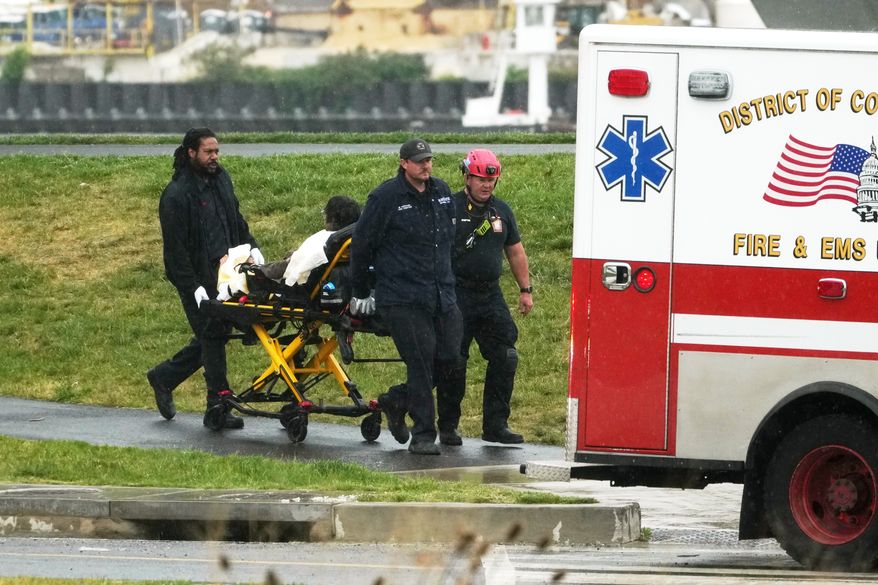 D.C. Fire and EMS wheel Guido Reichstadter, 45, to an ambulance, Wednesday, May 6, 2026, in Washington. Reichstadter, who scaled to the top of the Frederick Douglass Bridge in Washington last week, has come down, after his six-day protest. (AP Photo/Julia Demaree-Nikhinson)