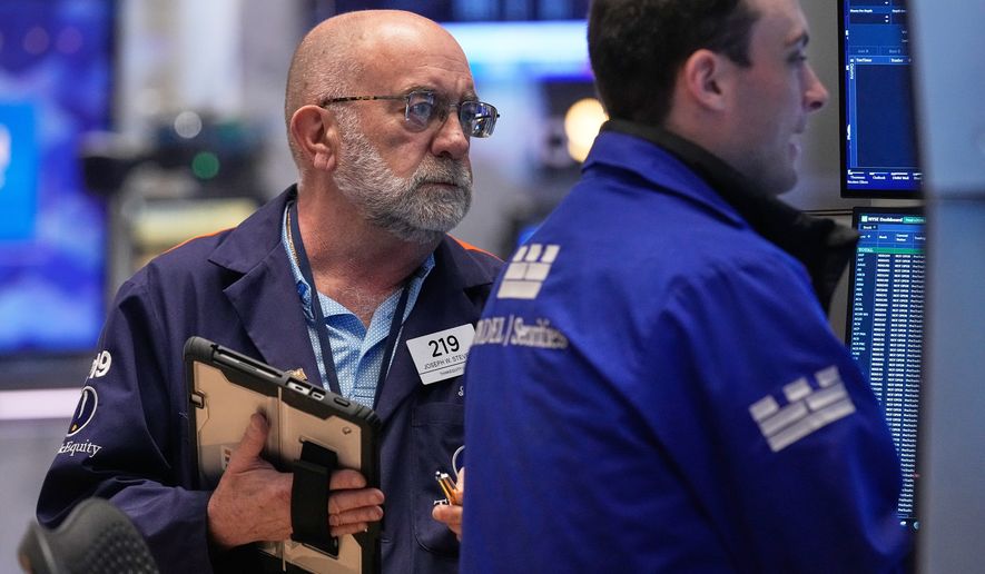 Trader Joseph Stevens, left, works on the floor of the New York Stock Exchange, Tuesday, May 5, 2026. (AP Photo/Richard Drew)