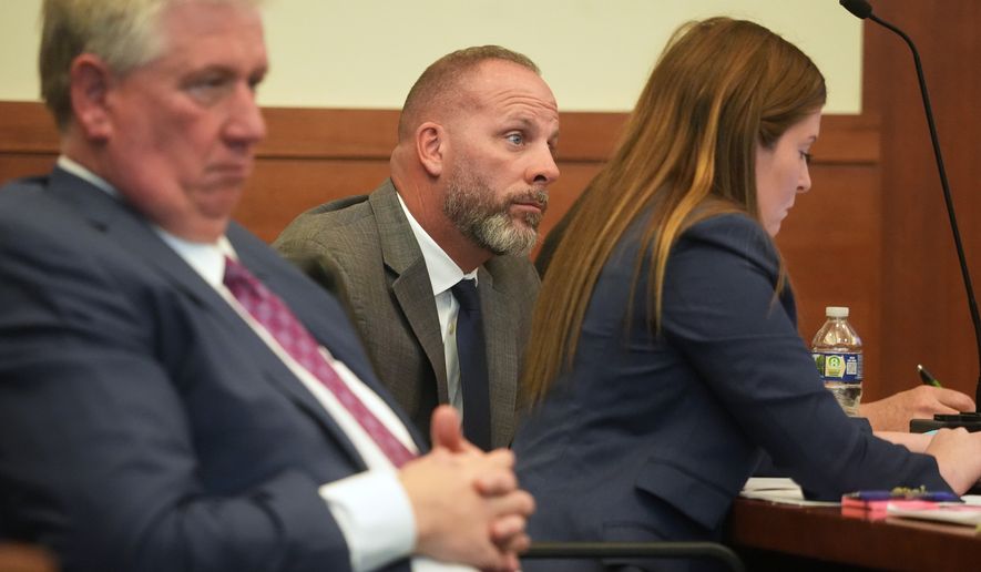 FILE - Jason Meade, center, sits with his attorneys Mark Collins, left, and Kaitlyn Stephens, right, during opening statements in the retrial of the former Ohio sheriff's deputy charged with murder and reckless homicide in the 2020 killing of Casey Goodson Jr., inside Franklin County Common Pleas Court in Columbus, Ohio, April 23, 2026. (Doral Chenoweth/Pool photo via AP, File)