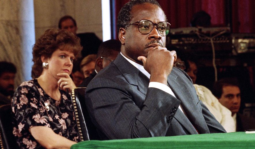 Supreme Court Justice Nominee Clarence Thomas and his wife Virginia listen during his nomination hearing before the Senate Judiciary Committee on Capitol Hill in Washington, Sept. 10, 1991. (AP Photo/Doug Mills, File)