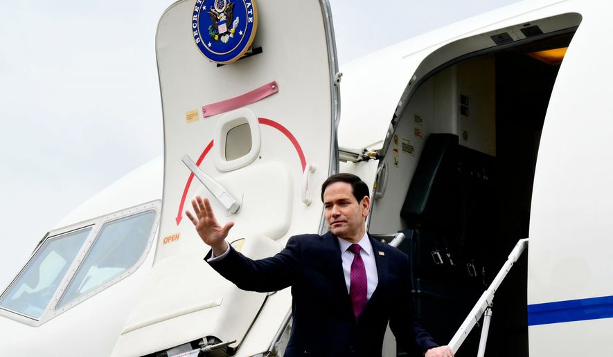 US Secretary of State Marco Rubio waves as he boards a US government aircraft after concluding his two-day visit to Italy and the Vatican, at Ciampino airport in Rome, Friday, May 8, 2026. (Stefano Rellandini/Pool Photo via AP)