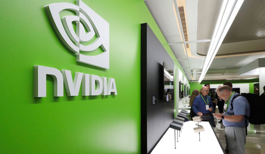 People take a look at Nvidia's new products during the Computex 2025 exhibition in Taipei, Taiwan, Wednesday, May 21, 2025. (AP Photo/Chiang Ying-ying, File)