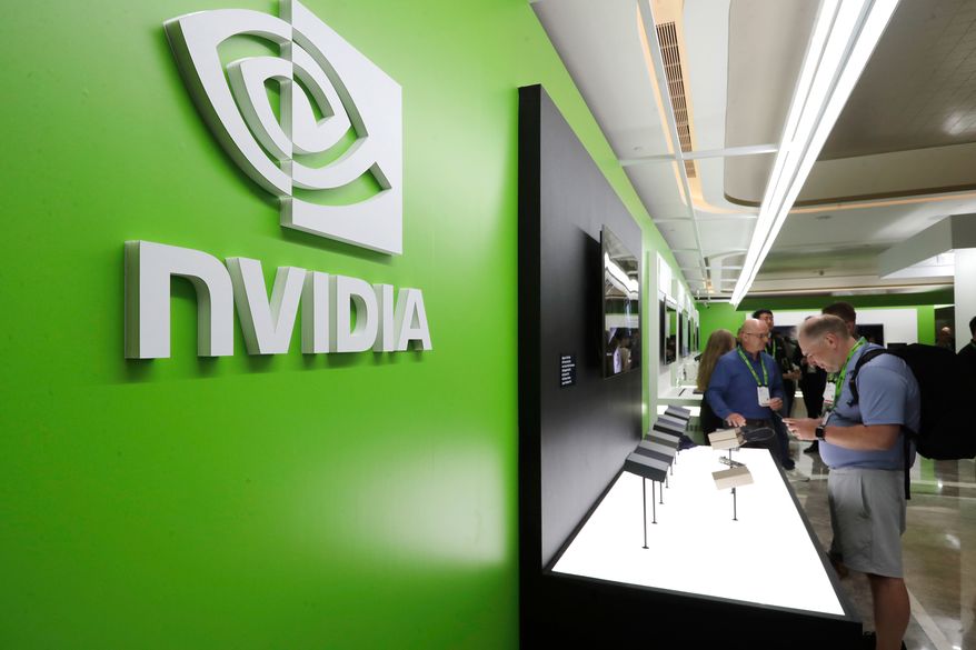 People take a look at Nvidia's new products during the Computex 2025 exhibition in Taipei, Taiwan, Wednesday, May 21, 2025. (AP Photo/Chiang Ying-ying, File)