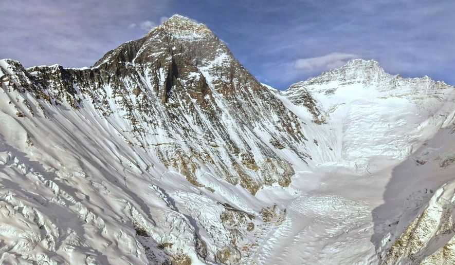 Mount Everest is seen, center left, from base camp in Nepal, Sunday, May 10, 2026. (AP Photo/Pasang Rinzee Sherpa)