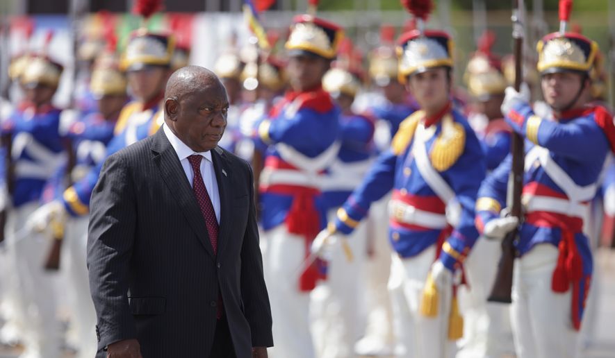 South Africa's President Cyril Ramaphosa receives military honors during a welcome ceremony at the Planalto Presidential Palace, prior to a meeting with Brazilian President Luiz Inacio Lula da Silva in Brasilia, Brazil, March 9, 2026. (AP Photo/Luis Nova, File)