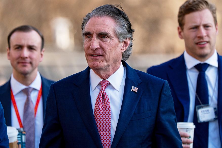 FILE - Interior Secretary Doug Burgum, center, is seen at the White House, March 11, 2026, in Washington. (AP Photo/Alex Brandon, File)