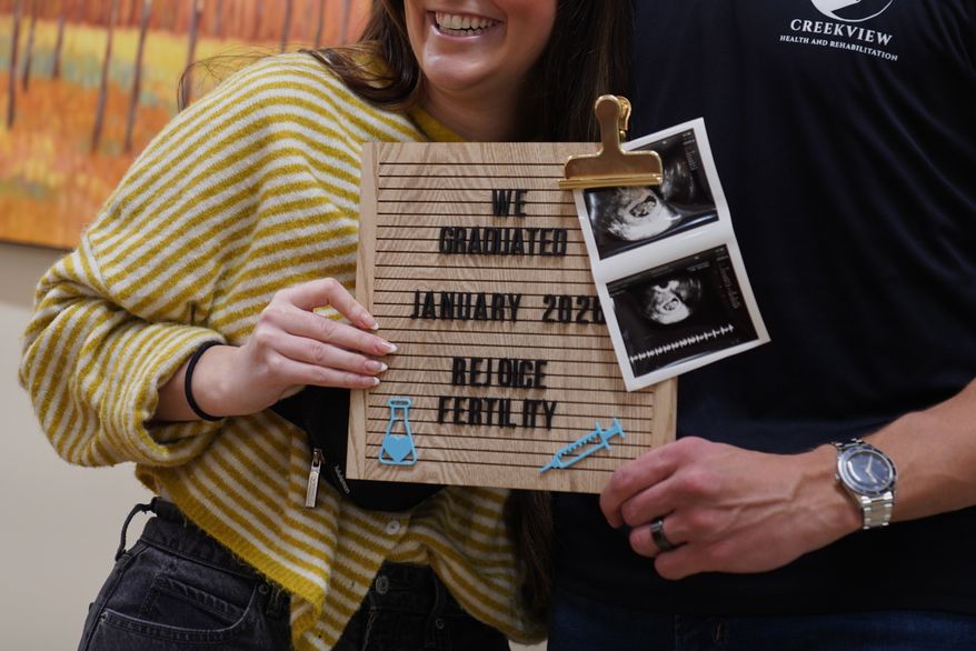 IVF patients Maggie and Cade Lichfield take a photo after getting their final ultrasound at Rejoice Fertility, Jan. 9, 2026, in Knoxville, Tenn. (AP Photo/Jessie Wardarski)