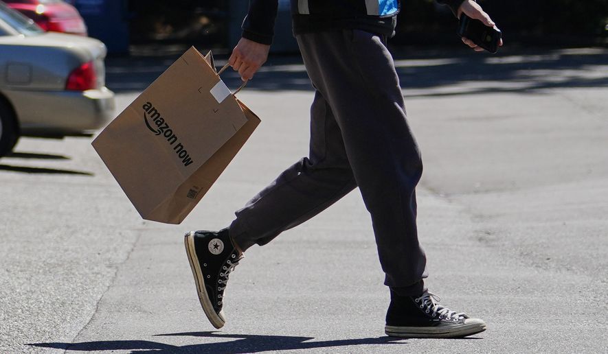 A driver picks up an order at an Amazon Now location, Monday, May 11, 2026, in Bellevue, Wash. (AP Photo/Lindsey Wasson)