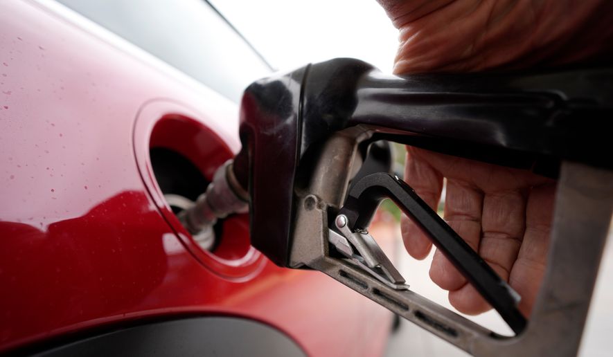FILE - A motorist pumps fuel at a Shell station Wednesday, July 5, 2023, in Englewood, Colo. (AP Photo/David Zalubowski, File)