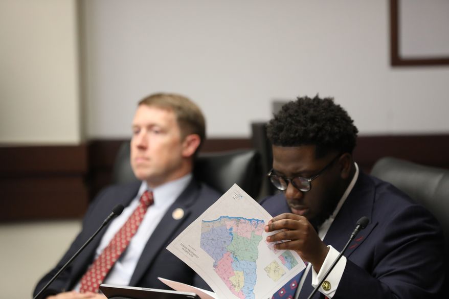 South Carolina Democratic Rep. Keishan Scott looks at a proposed U.S. House district map during a redistricting hearing in a state House Judiciary subcommittee on Tuesday, May, 12 2026, in Columbia, S.C. (AP Photo/Jeffrey Collins)