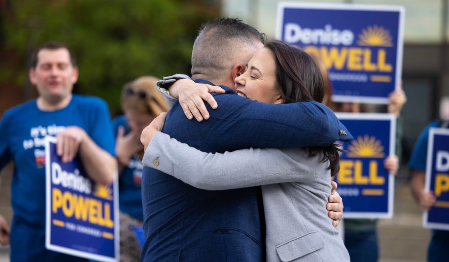 Denise Powell hugs her husband, Hobson, after voting in the Nebraska Primary Election at Omaha Community Playhouse Tuesday, May 12, 2026, in Omaha, Neb. Powell is a candidate for the Democratic nomination to the House of Representatives in Nebraska's second district. (AP Photo/Rebecca S. Gratz)