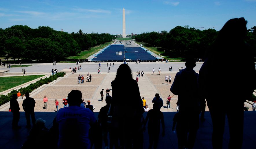 Tourists visit the Lincoln Memorial as workers apply a blue protective coating to the Lincoln Memorial Reflecting Pool, Tuesday, May 12, 2026, in Washington. (AP Photo/Rahmat Gul)
