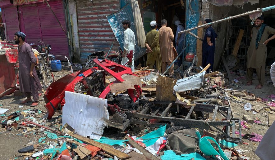 Local residents examine damage at the site of a bomb explosion at a market in Sarai Norag in Lakki Marwat, a district in Pakistan's Khyber Pakhtunkhwa province, Tuesday, May 12, 2026. (AP Photo/Farhat Ullah)