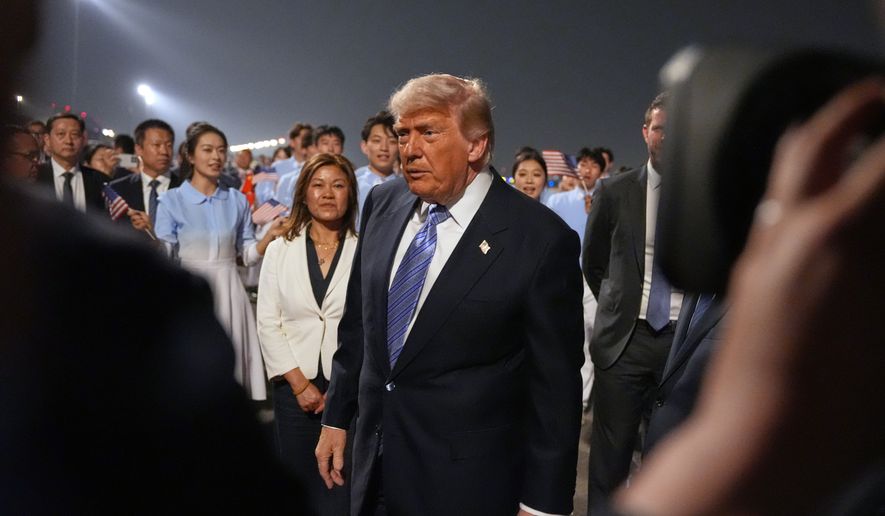 President Donald Trump walks during a welcome ceremony as he arrives on Air Force One, Wednesday, May 13, 2026, at Beijing Capital International Airport in Beijing. (AP Photo/Mark Schiefelbein)