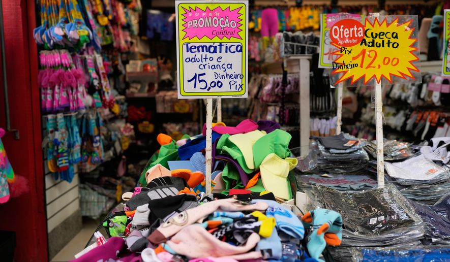 A sign offers payment via Pix, a free payment system, at a store in Rio de Janeiro, Thursday, April 16, 2026. (AP Photo/Silvia Izquierdo)