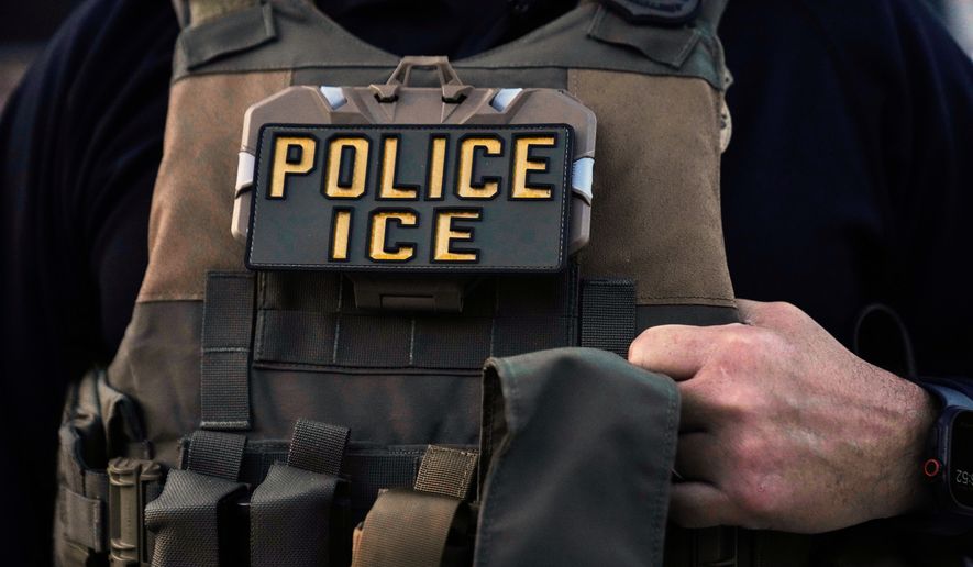 A U.S. Immigration and Customs Enforcement agent is seen in Park Ridge, Ill., Sept. 19, 2025. (AP Photo/Erin Hooley, File)