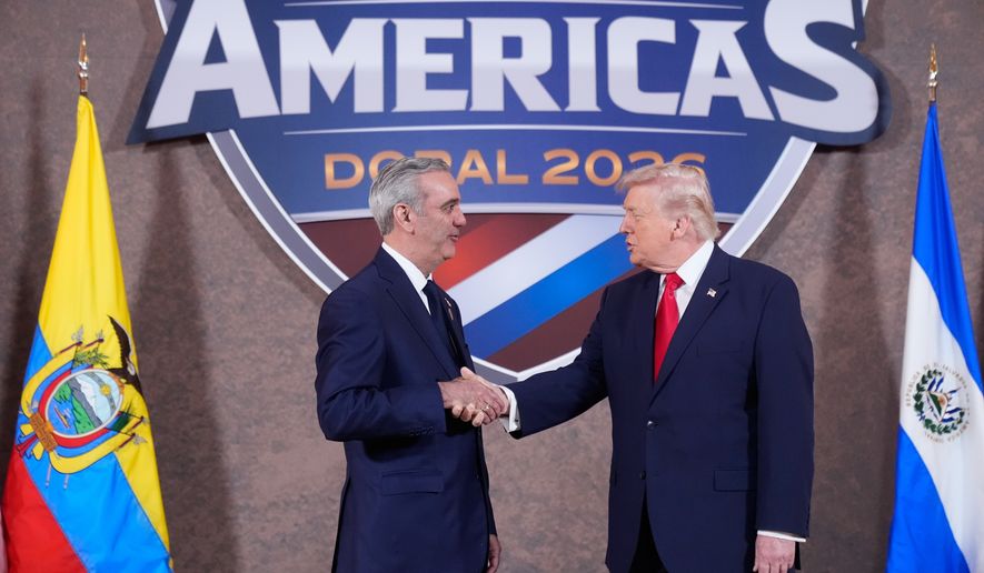 FILE - President Donald Trump greets President of the Dominican Republic Luis Abinader at the Shield of the Americas Summit, March 7, 2026, at Trump National Doral Miami in Doral, Fla. (AP Photo/Mark Schiefelbein, File)