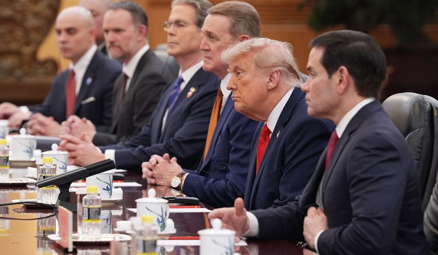 President Donald Trump listens as he meets with China's President Xi Jinping at the Great Hall of the People, Thursday, May 14, 2026, in Beijing. (AP Photo/Mark Schiefelbein)