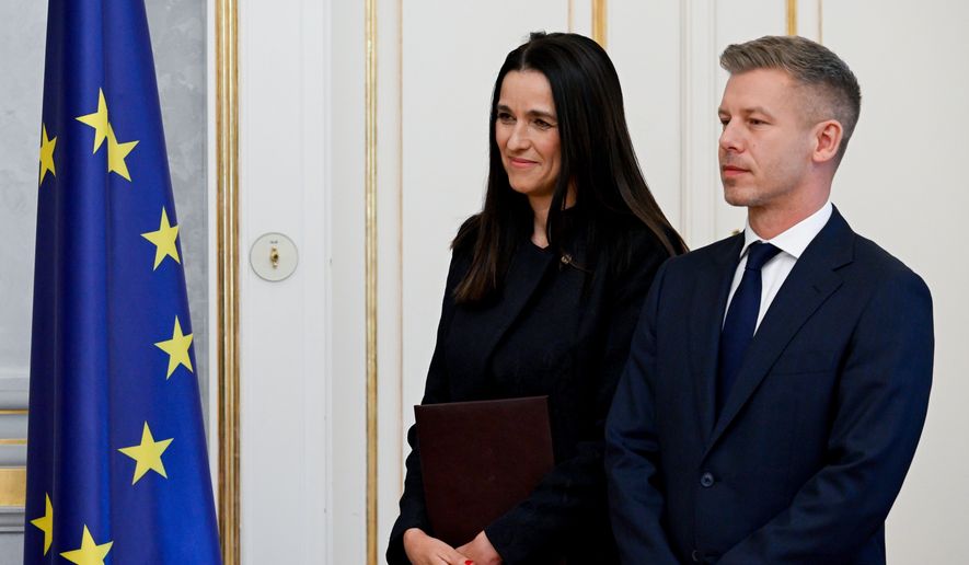 Prime Minister Peter Magyar, right, and Foreign Minister Anita Orban during the appointment ceremony of ministers of the Tisza government at the presidential Alexander Palace in Budapest, Hungary, Tuesday, May 12, 2026. (Szilard Koszticsak/MTI via AP)