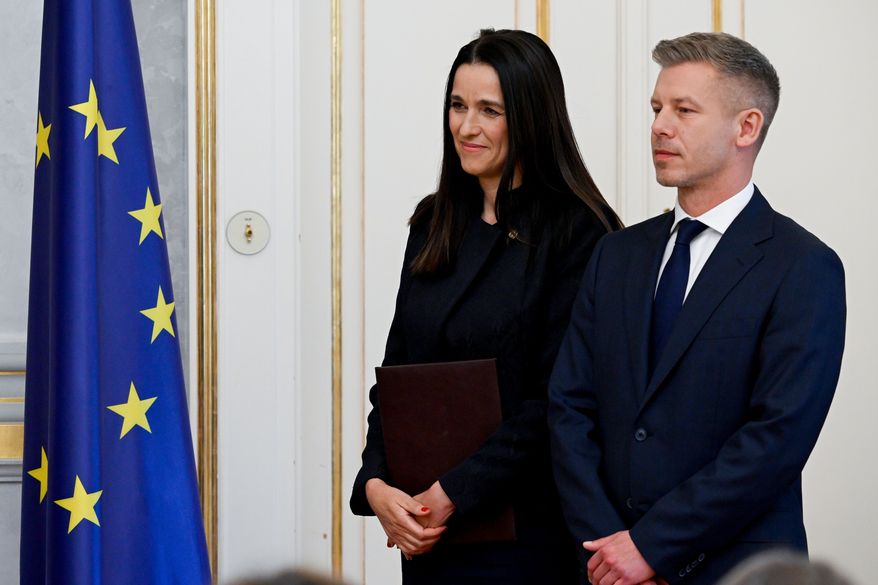 Prime Minister Peter Magyar, right, and Foreign Minister Anita Orban during the appointment ceremony of ministers of the Tisza government at the presidential Alexander Palace in Budapest, Hungary, Tuesday, May 12, 2026. (Szilard Koszticsak/MTI via AP)