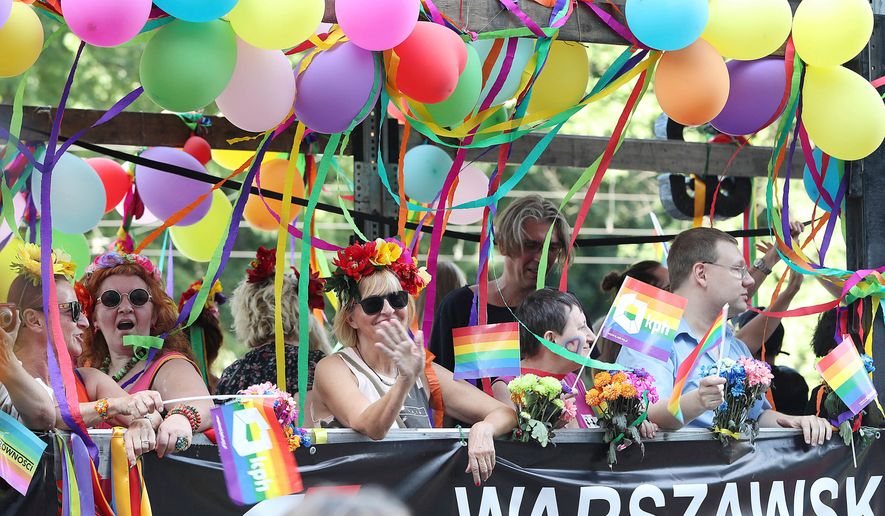 FILE - People take part in the Gay Pride parade in Warsaw, Poland, June 9, 2018. (AP Photo/Czarek Sokolowski, file)
