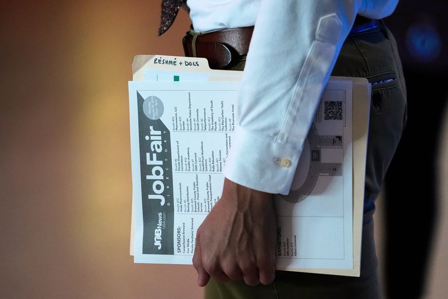A person waits in line for a prospective employer at a job fair in Sunrise, Fla., on Aug. 29, 2024. (AP Photo/Lynne Sladky) **FILE**