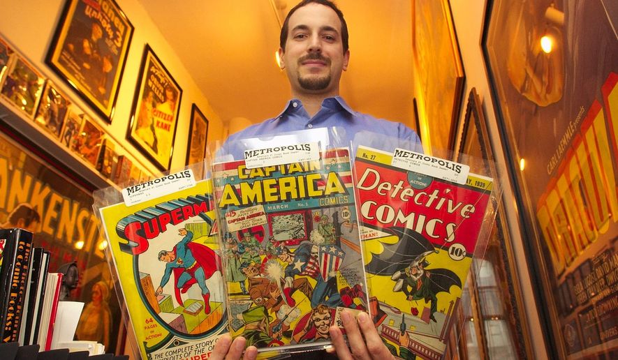 File - Vincent Zurzolo, co-partner of Metropolis Collectibles, holds three examples of the company's vast collection of comic books in their offices in New York, Thursday, July 10, 2003. (AP Photo/Gregory Bull, File)