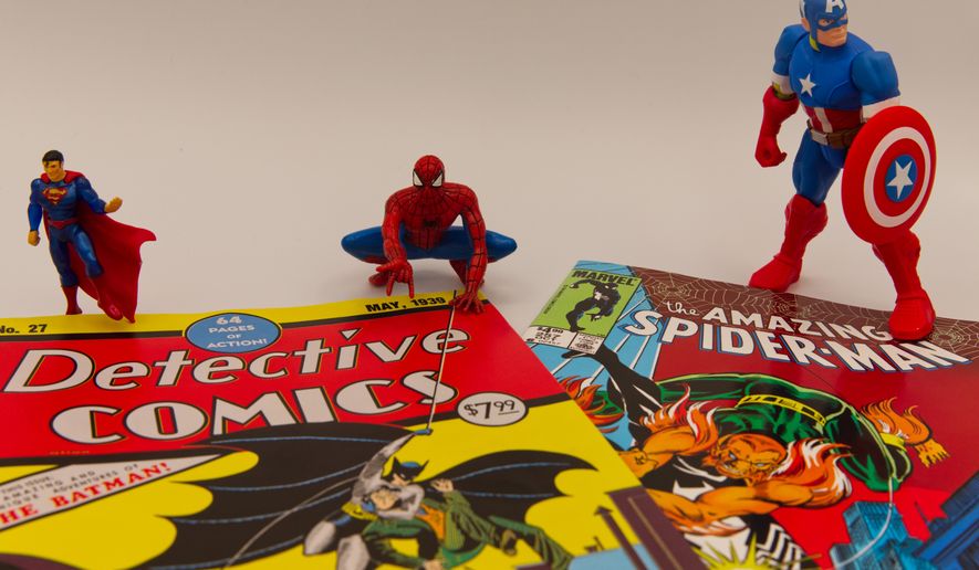 Famous comic book superhero figurines stand next to facsimile copies of comic book issues in Phoenix, May 14, 2026. (AP Photo/Dario Lopez-Mills)