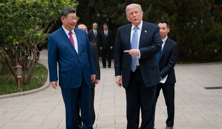 U.S. President Donald Trump gestures towards Chinese President Xi Jinping while leaving after a visit to the Zhongnanhai Garden in Beijing, Friday, May 15, 2026. (Evan Vucci/Pool Photo via AP)