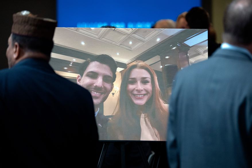 Visitors walk past a photo of slain Israeli Embassy staff members Yaron Lischinsky, left, and Sarah Milgrim, right, before a service to mark the reopening of the Capital Jewish Museum after the two were killed following an event at the museum, May 29, 2025, in Washington. (AP Photo/Mark Schiefelbein, File)