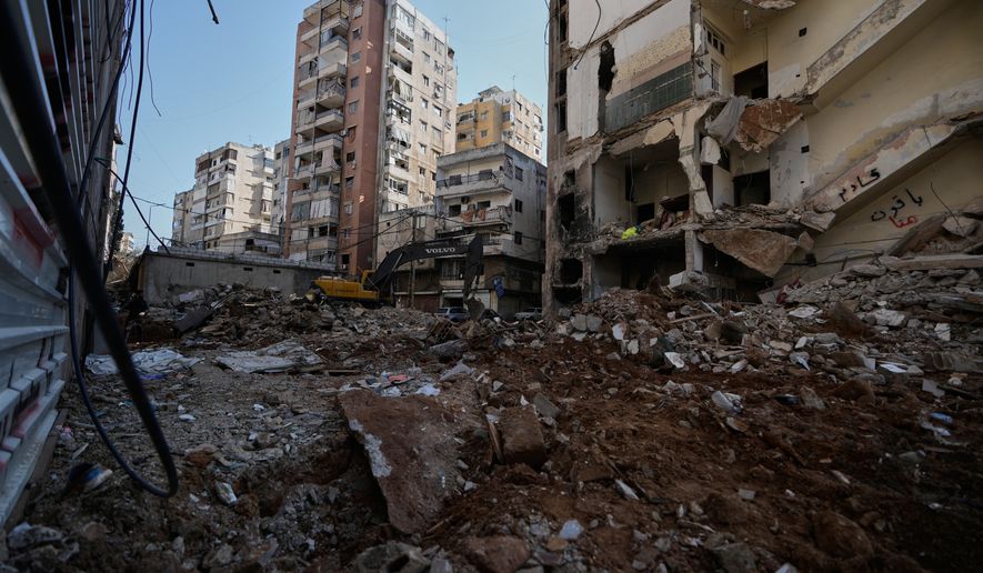 A bulldozer clears the rubble where a sports clothing shop was destroyed in a previous Israeli airstrike in Chiyah, a southern Beirut suburb, May 6, 2026. (AP Photo/Bilal Hussein)