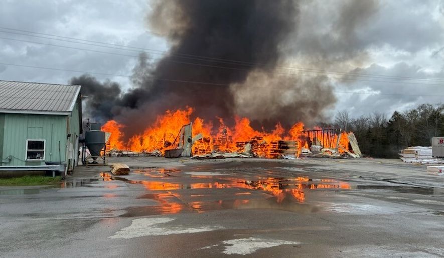This photo provided by the Maine Department of Public Safety shows flames from a large fire at Robbins Lumber in Searsmont, Maine on Friday, May 15, 2026 (Maine Department of Public Safety via AP)