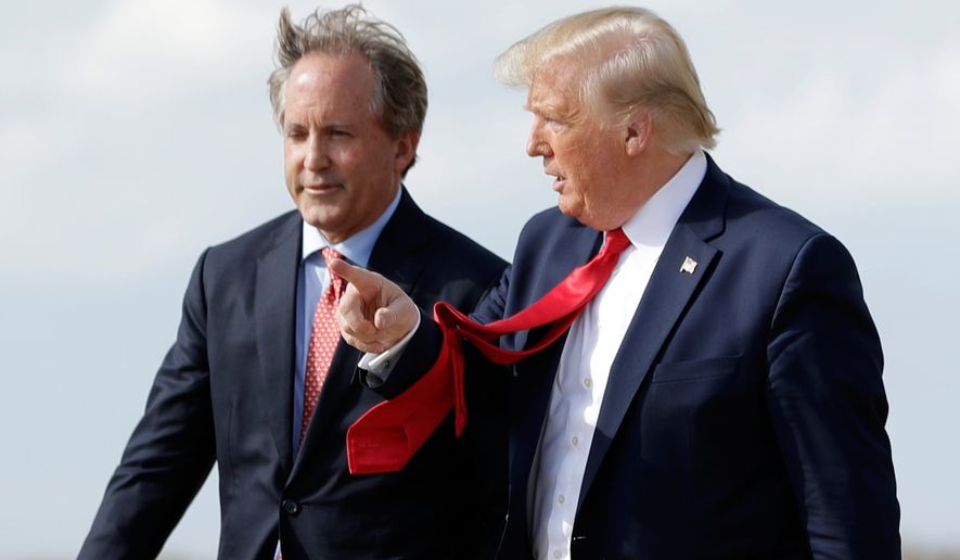 President Donald Trump walks with Texas Attorney General Ken Paxton, left, at Austin-Bergstrom International Airport in Austin, on Wednesday, Nov. 20, 2019. (AP Photo/Evan Vucci) **FILE**