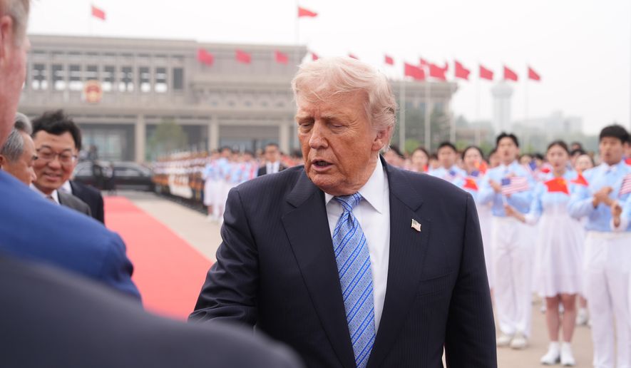 President Donald Trump is greeted by officials before boarding Air Force One, Friday, May 15, 2026, at Beijing Capital International Airport in Beijing. (AP Photo/Mark Schiefelbein)