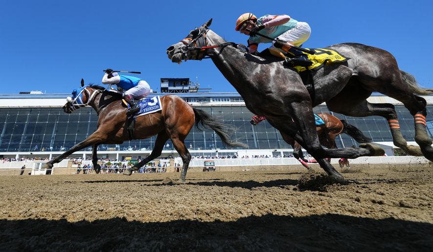 Jeiron Barbosa, left, atop Wickeddivine, edges out Irad Ortiz Jr., right, atop Freeze the Fire, to win an undercard race ahead of the 151st running of the Preakness Stakes horse race, Saturday, May 16, 2026, at Laurel Park in Laurel, Md. (AP Photo/Julia Demaree Nikhinson)