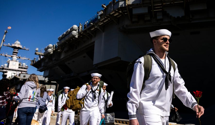 Sailors make their way to their loved ones after disembarking from the USS Gerald R. Ford at Naval Station Norfolk in Norfolk, Va. on Saturday, May 16, 2026, following an 11 month deployment. (Kendall Warner/The Virginian-Pilot via AP)