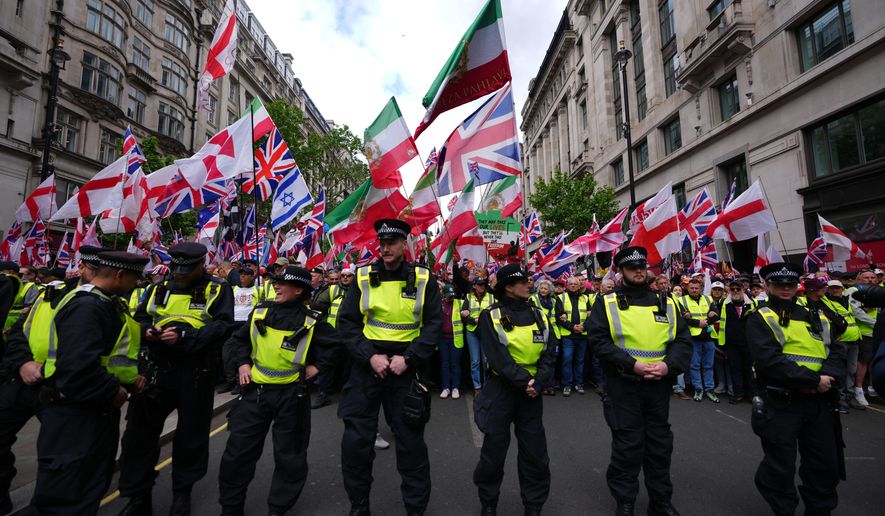 Police forces stand in front of the far right Unite the Kingdom march in London, Saturday, May 16, 2026.(AP Photo/Kirsty Wigglesworth)
